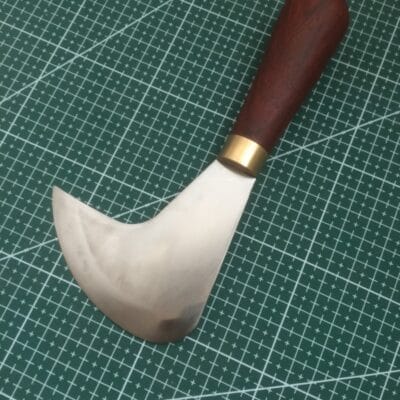 Curved leather pattern knife blade detail