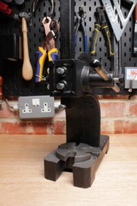 Arbor press mounted on a leathercraft workbench before fitting the adapter system.