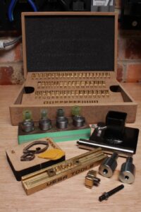 Leathercraft tooling and stamp system compatible with arbor press adapters.