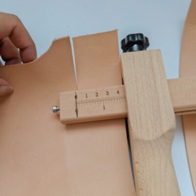 Kevin Lee wooden strap cutter cutting a leather strap