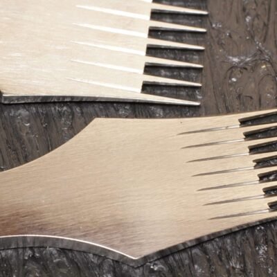 Two pricking irons on an Oka cutting board showing tine spacing comparison
