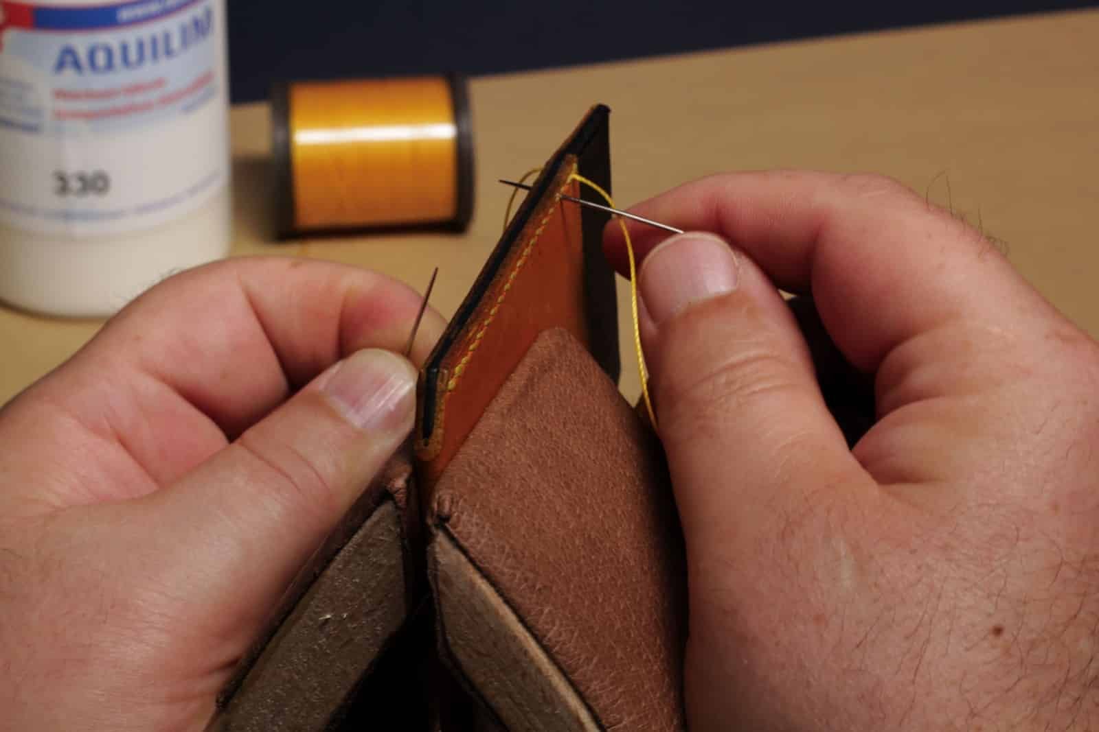 Hand stitching leather with waxed thread and a stitching tool