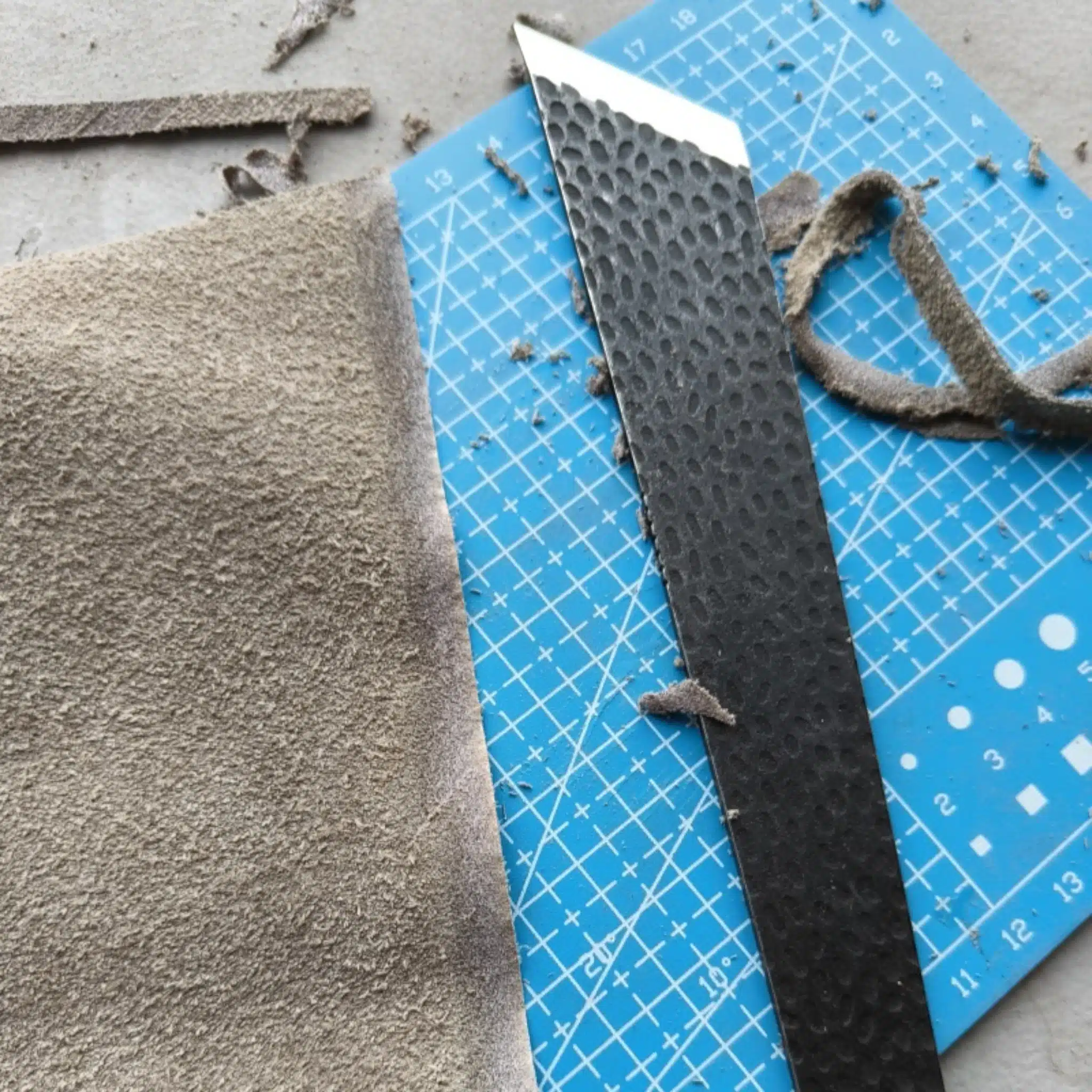 Kevin Lee D2 steel skiving knife cutting through a piece of leather