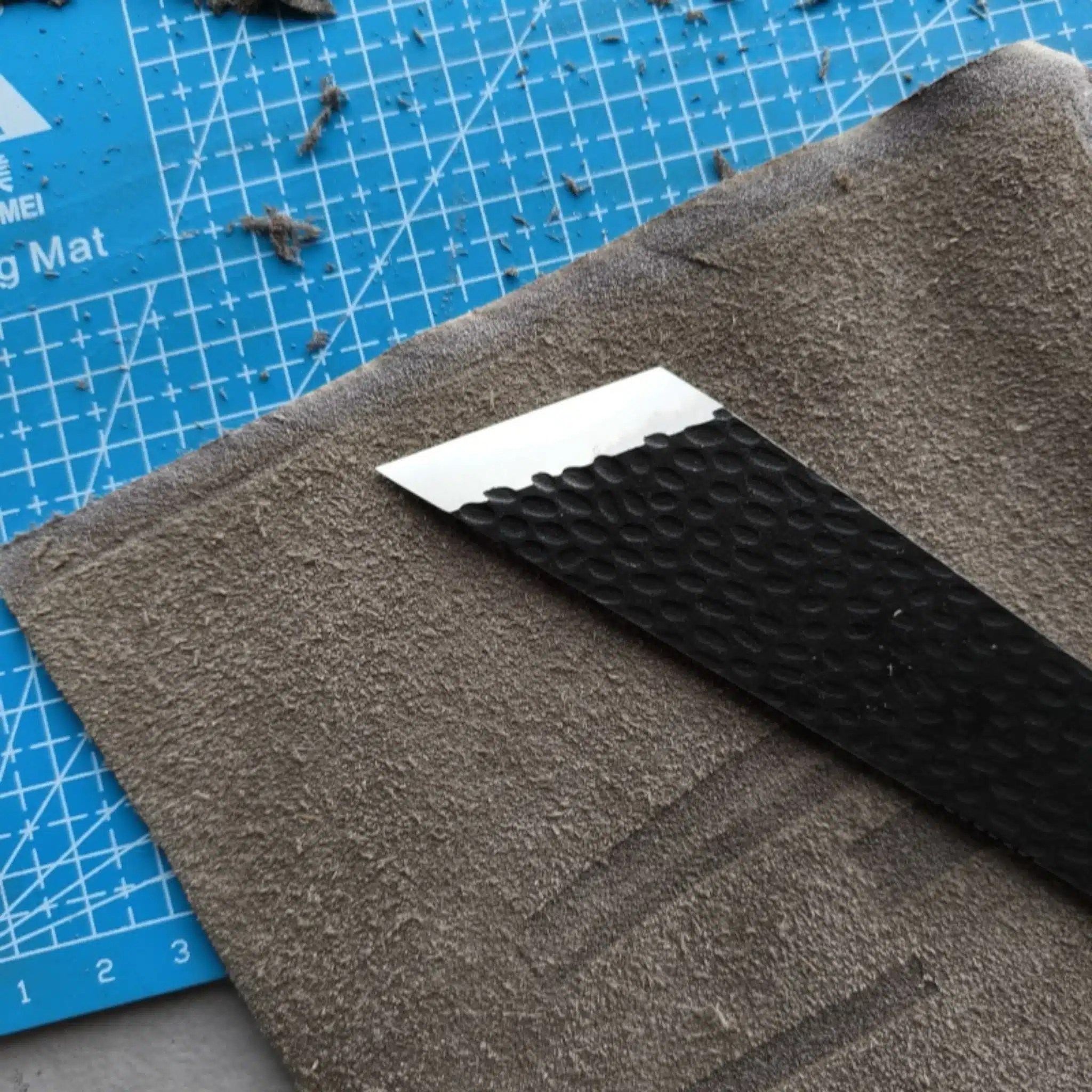 Kevin Lee D2 steel skiving knife shown in use skiving leather