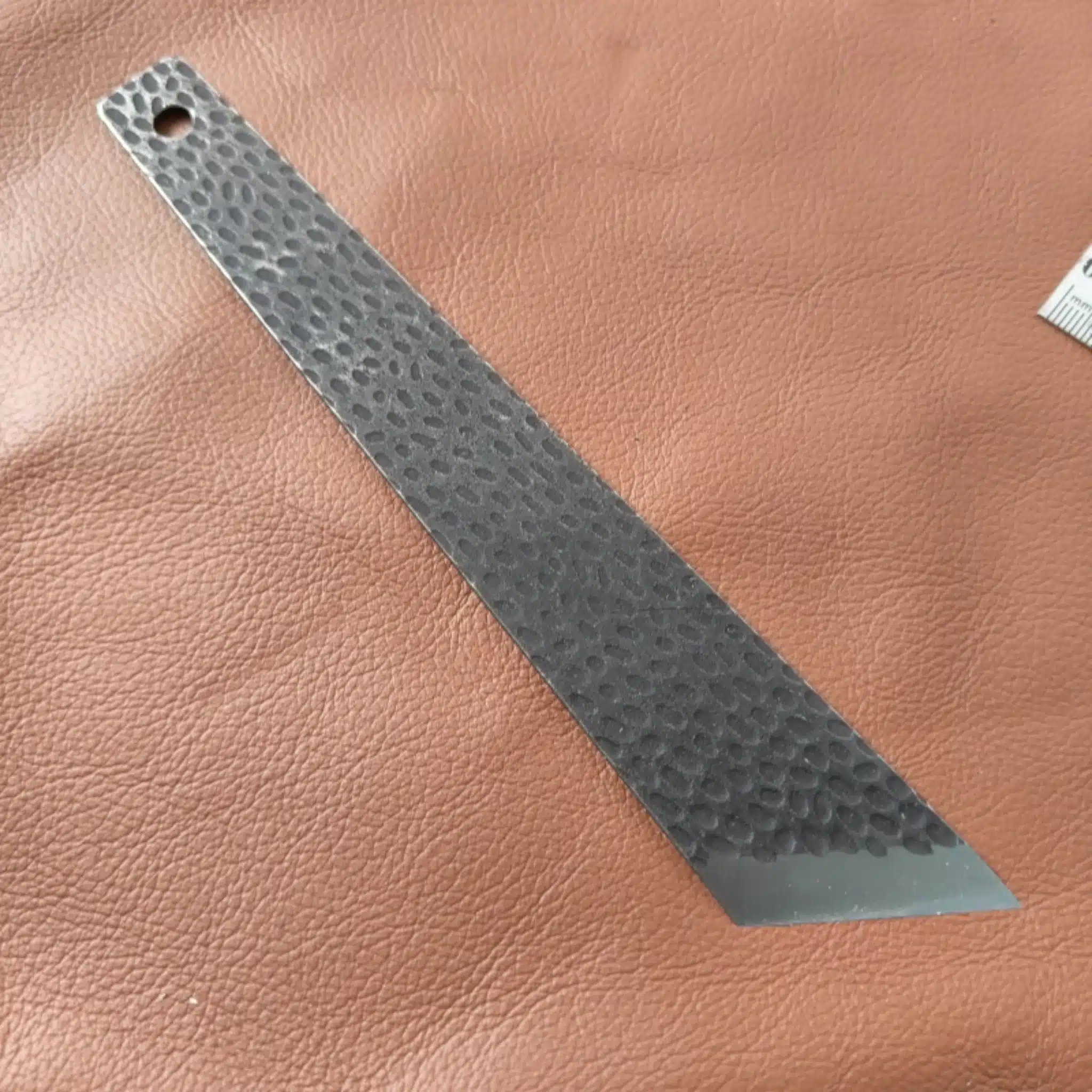 Kevin Lee D2 steel skiving knife resting on a piece of leather