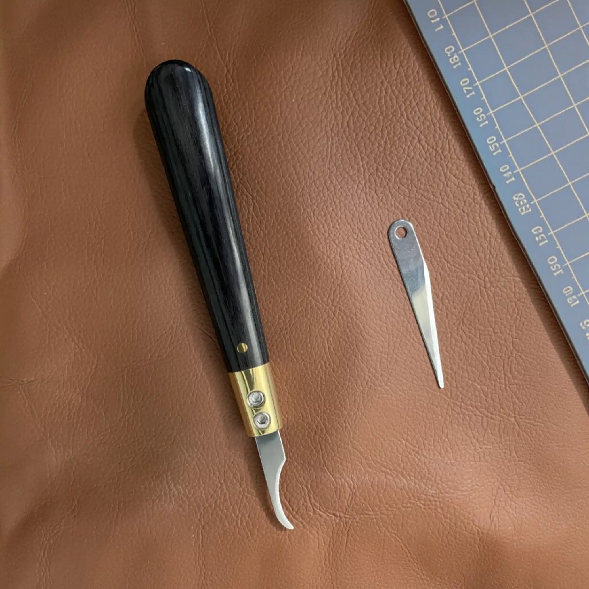Close-up detail of the Kevin Lee interchangeable-blade pattern knife handle
