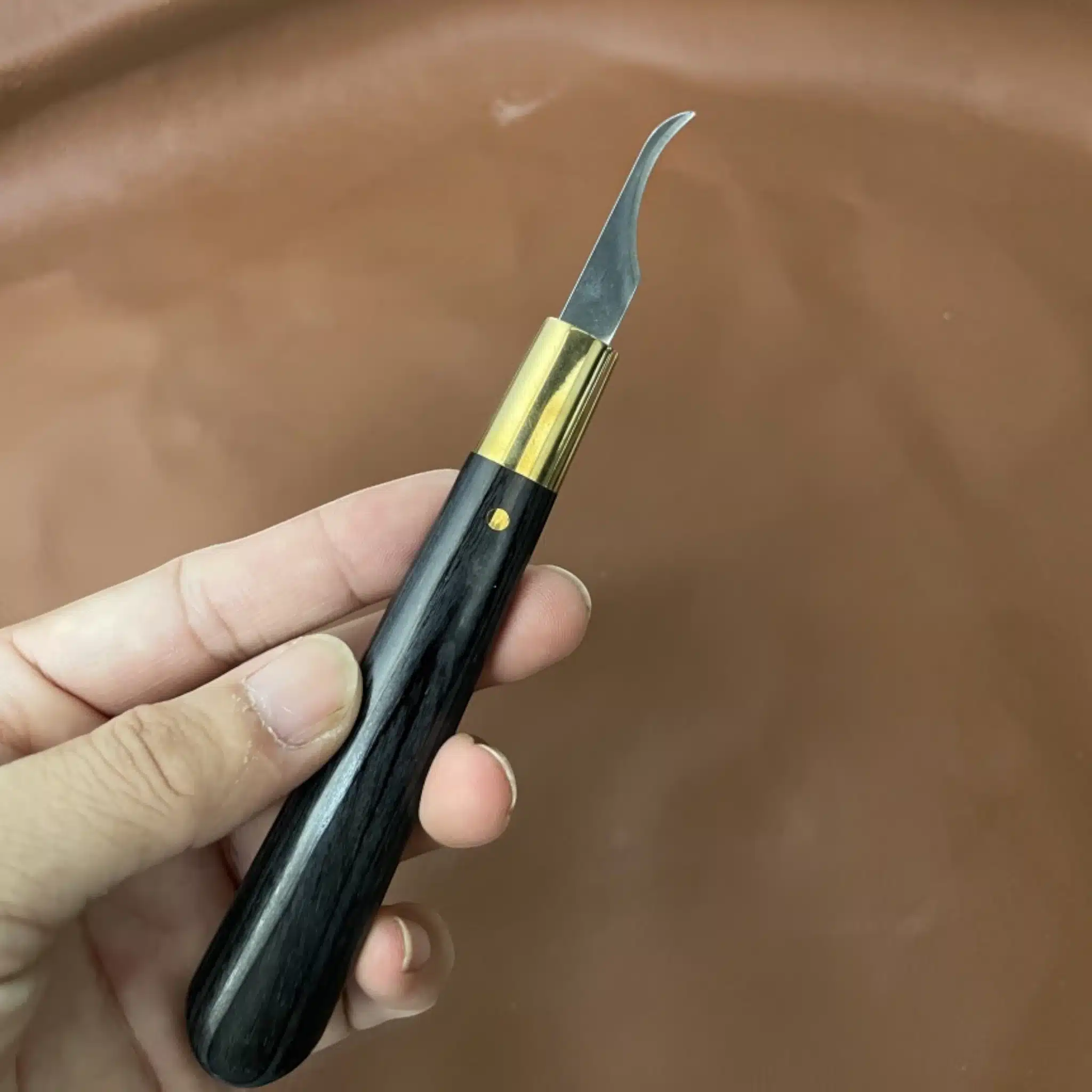 Kevin Lee interchangeable-blade pattern knife held in hand showing grip