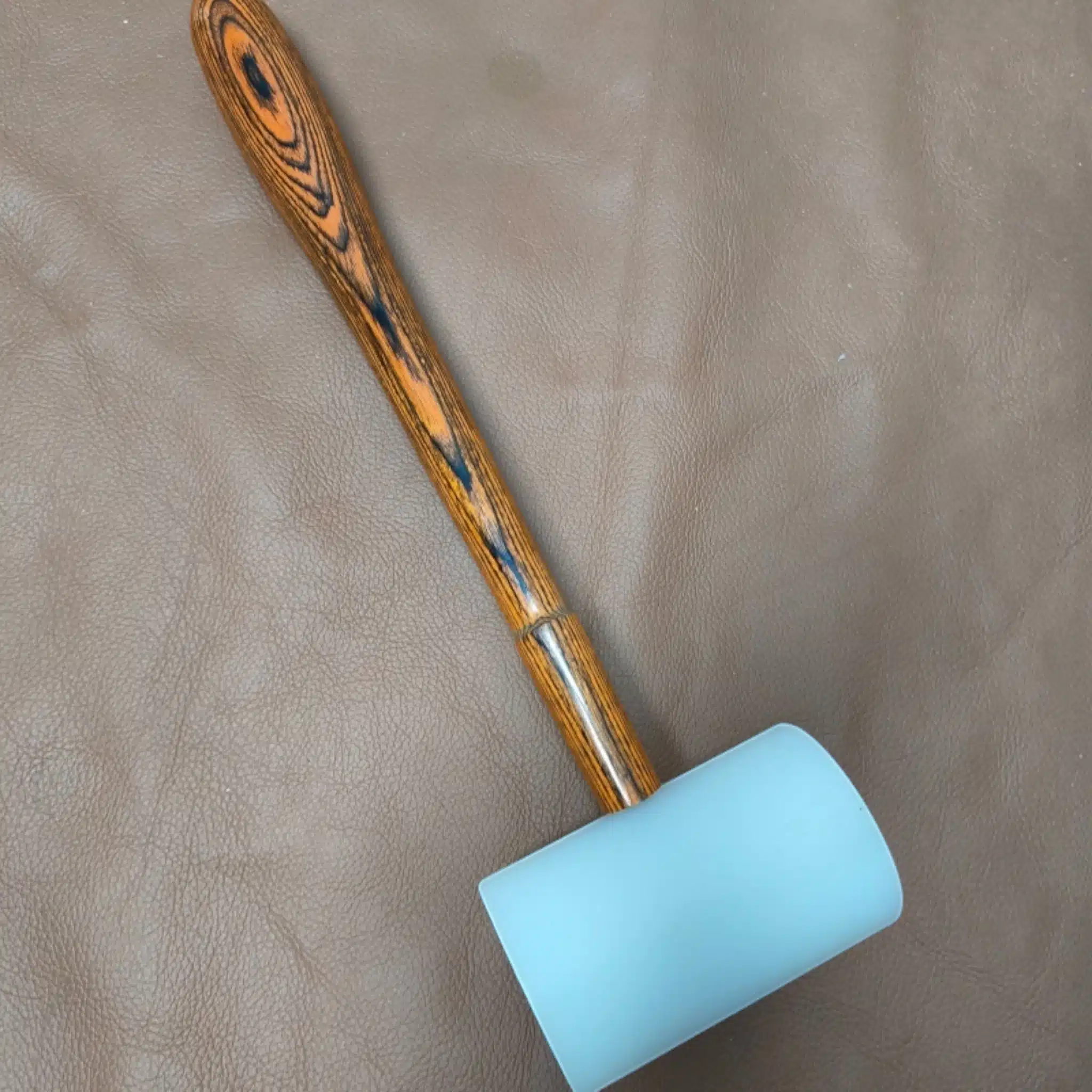 Kevin Lee nylon hammer resting beside leather on the bench