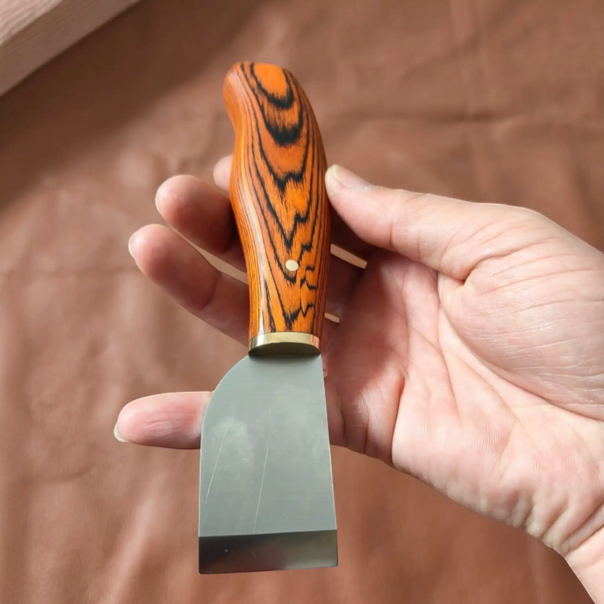 Kevin Lee premium Japanese-style knife held in hand showing grip