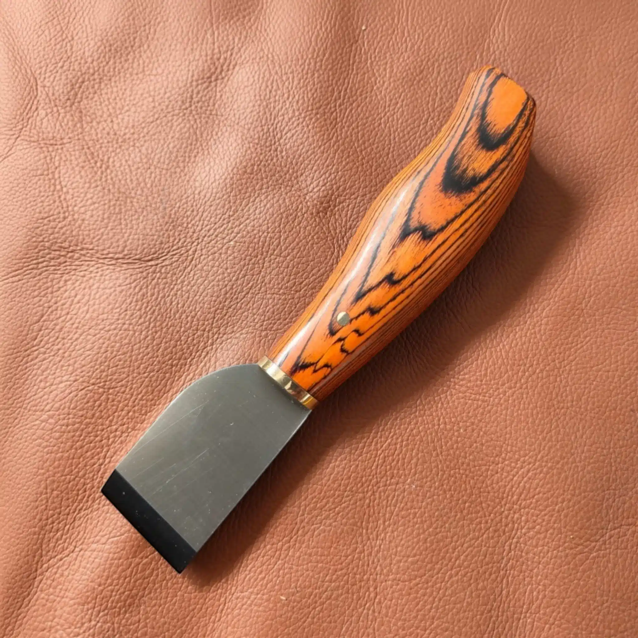 Kevin Lee premium Japanese-style knife resting on a piece of leather