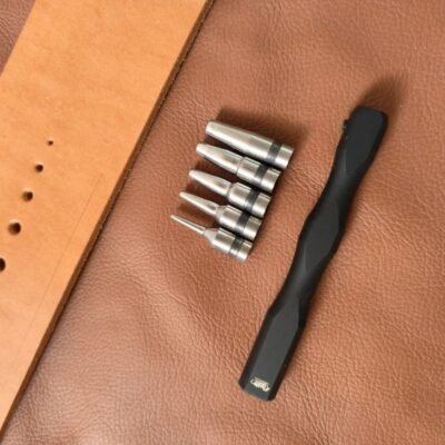 Kevin Lee Interchangeable-Tip Hole Punch Set – Tips and Sample Holes Kevin Lee interchangeable hole punch handle and tips displayed beside sample holes in leather