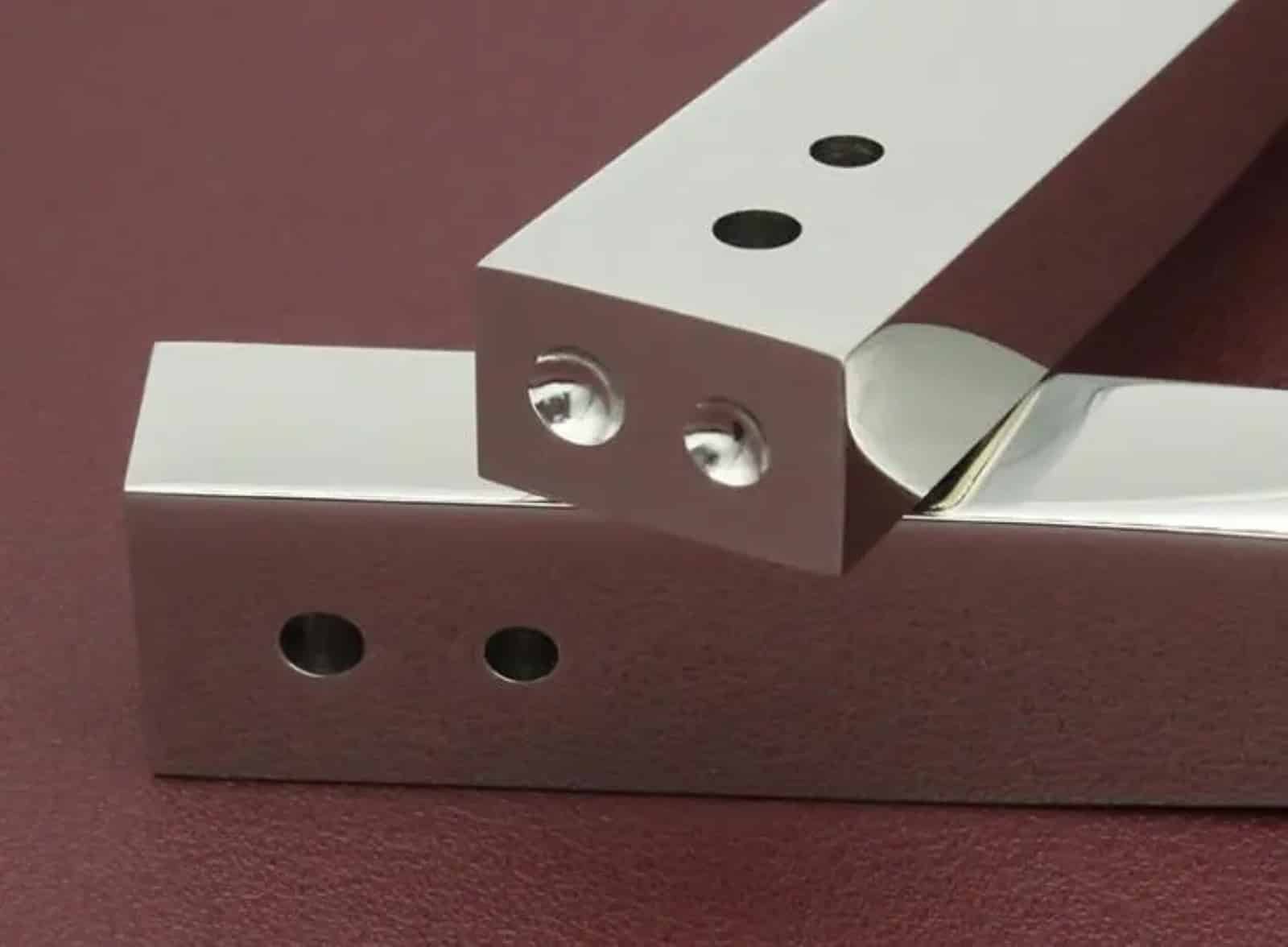 Close-up of the setting holes and rounded working recesses on the Kevin Lee rivet and burr setter