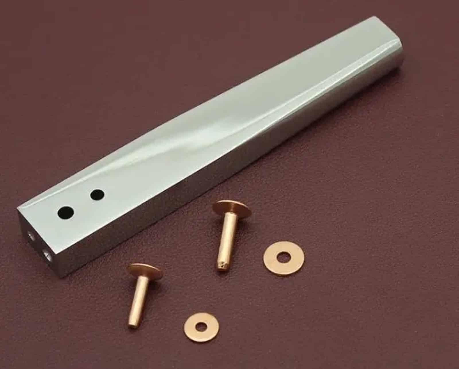 Kevin Lee polished steel multi-size rivet and burr setter shown with copper rivets and burrs