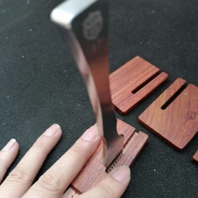 Kevin Lee rosewood pull-out board being used to release a pricking iron from leather