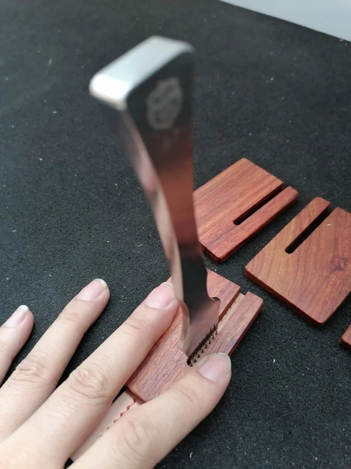 Kevin Lee rosewood pull-out board being used to release a pricking iron from leather