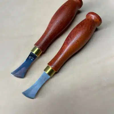 Two AIGAEER creasers with red handles and brass-coloured collars, heads marked 1.5 and 2.0
