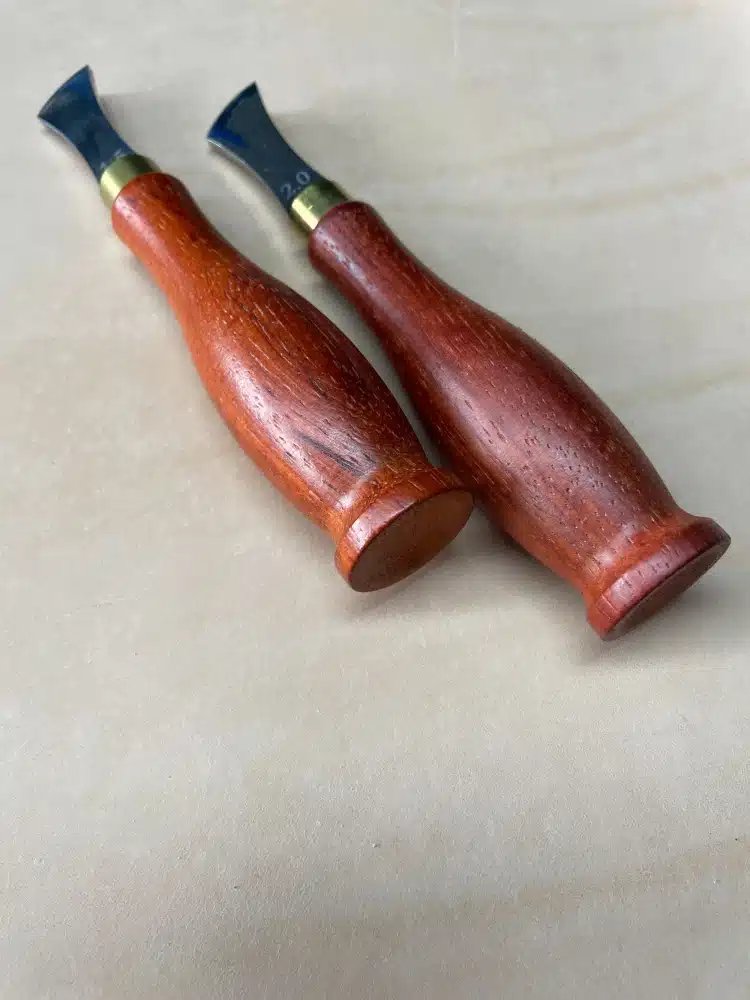 Two AIGAEER creasers with red handles viewed from the handle ends, one head marked 2.0