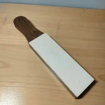 Kevin Lee Black Walnut Strop – Handle-End View Kevin Lee black walnut strop photographed from the handle end, showing the white stropping surface